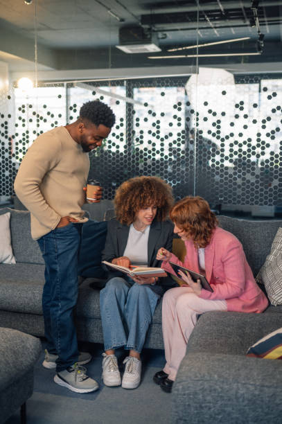 istock Interracial businesspeople collaborating on project with tablet in lobby 2154933875