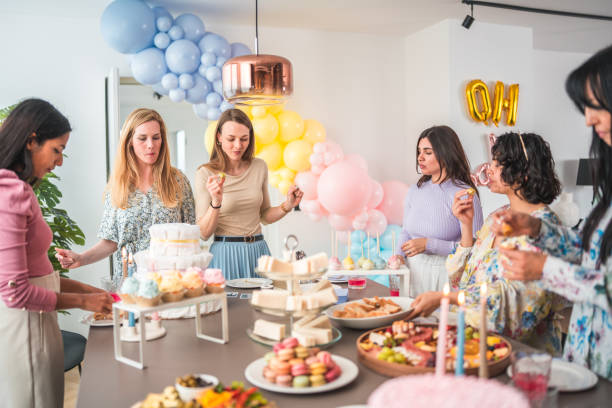 istock Diverse Friends Enjoying Catered Feast at Baby Shower 2154934948