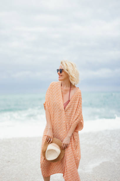 istock Smiling Woman Enjoying a Day at the Beach 2154941547