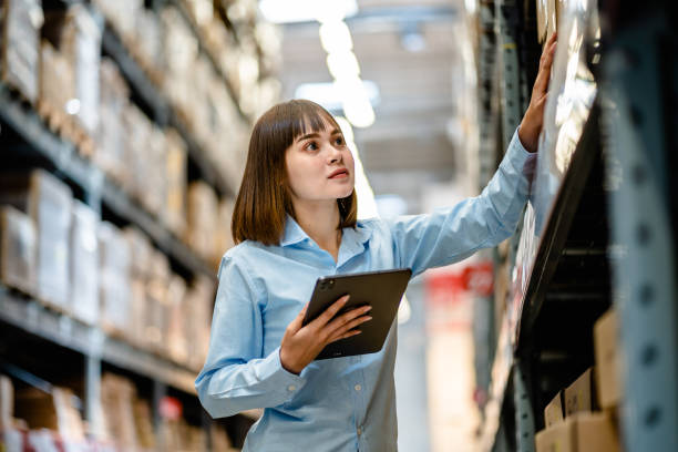 istock Women warehouse worker using digital tablets to check the stock inventory on shelves in large warehouses, a Smart warehouse management system, supply chain and logistic network technology concept 2154942176