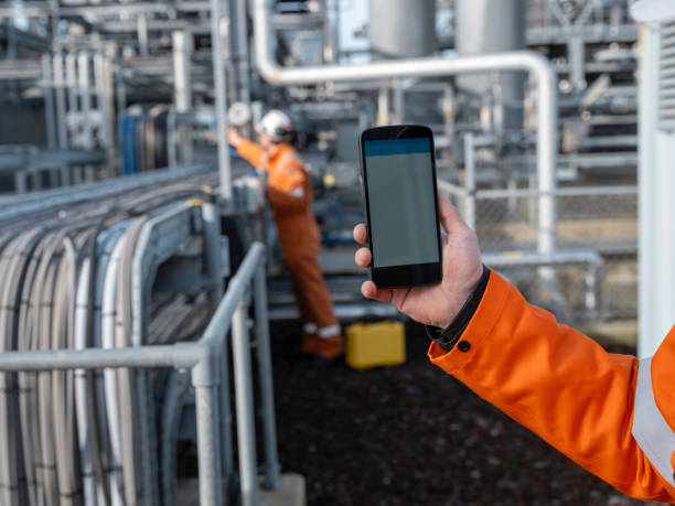 istock Industrial Worker with Smartphone at Electrical Installation Site 2154942511