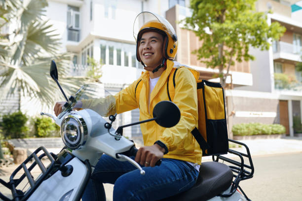 istock Smiling Courier Riding Motorbike 2154947614