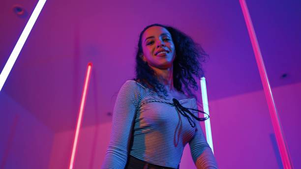 istock Low angle camera of hispanic dancer looking at camera and dancing. Regalement. 2154947695