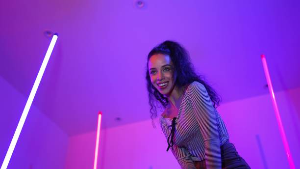 istock Low angle camera of hispanic dancer looking at camera and dancing. Regalement. 2154947717