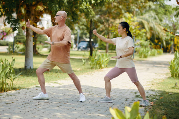 istock Mature Man and Woman Doing Tai Chi Exercises 2154948049
