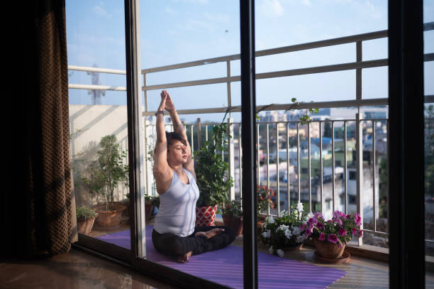 istock Peaceful Meditation on a Sunlit Balcony with City View 2154949326