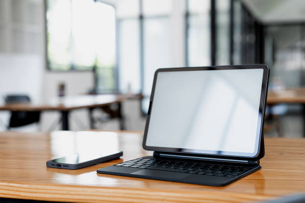 istock Mockup blank screen laptop and mobile phone on wooden table. 2154949920