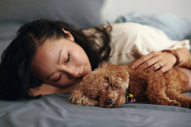 istock Woman Fell Asleep Hugging Dog 2154949929