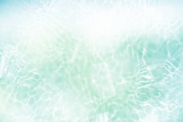 istock Blue water with ripples on the surface. Defocus blurred transparent blue colored clear calm water surface texture with splashes and bubbles. Water waves with shining pattern texture background. 2154950047