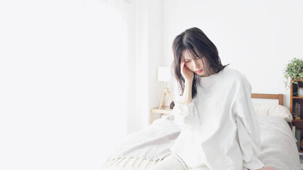 istock A woman suffering from a headache 2154951507