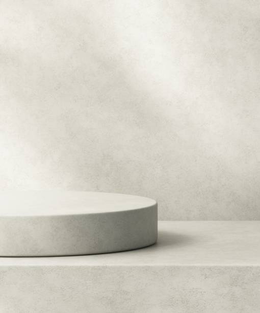 istock Gray polished cement podium on counter, soft beautiful dappled sunlight, leaf shadow on wall 2154951588