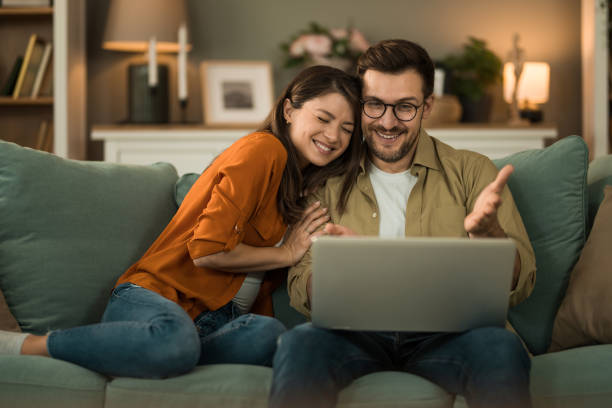 istock Couple browsing the net on laptop at home. 2154951591