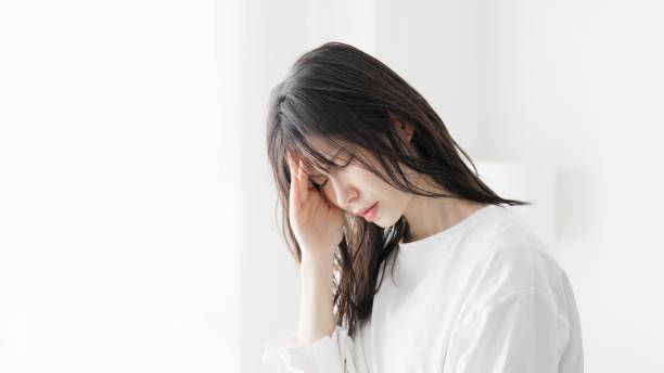 istock A woman suffering from a headache 2154951610