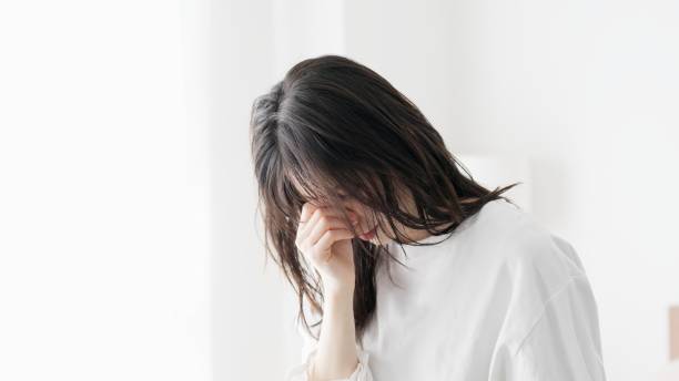 istock A woman holding her tired eyes 2154951611