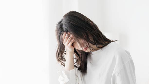 istock A woman suffering from a headache 2154951614