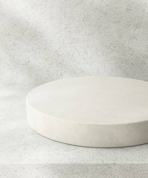 istock White podium on counter, soft beautiful dappled sunlight, leaf shadow on terrazzo texture wall 2154951669