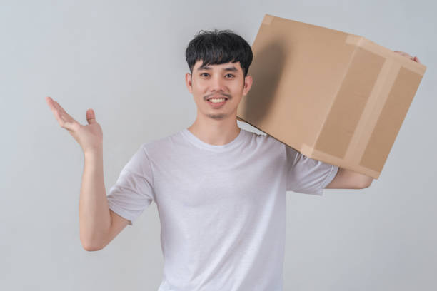 istock Handsome young man holding parcel box and with happy smile face. 2154952819