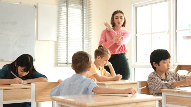 istock Professional teacher explain classwork to caucasian boy at classroom. Pedagogy. 2154953130