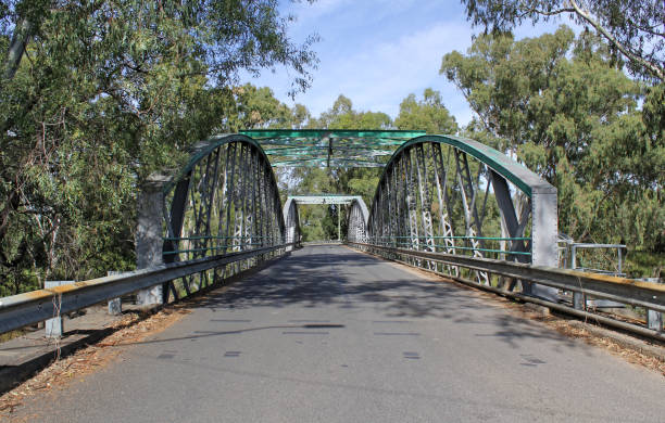istock Border Bridge with arches crossing the Macintyre River surrounded by trees under a blue sky in Goondiwindi, Queensland, Australia 2154953883