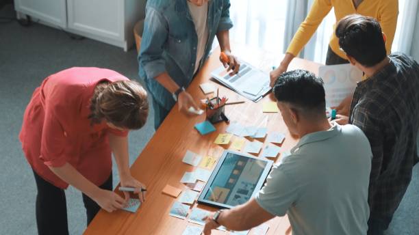 istock Top view of manager writing idea on sticky notes and explain idea. Symposium. 2154954725