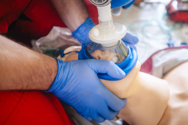 Hands of paramedic of emergency medical service during training resuscitation training on dummy. Themes rescue, urgency and health care.