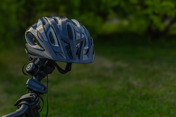 istock Protective bicycle helmet mounted on handlebars, protecting the cyclist's head 2154955526