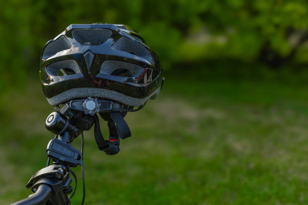 istock Protective bicycle helmet mounted on handlebars, protecting the cyclist's head 2154955529