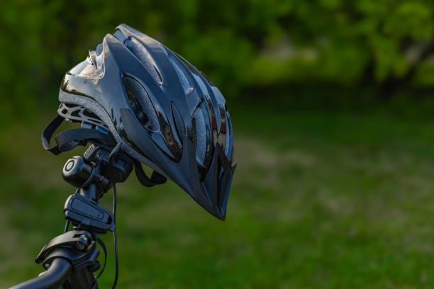 istock Protective bicycle helmet mounted on handlebars, protecting the cyclist's head 2154955533