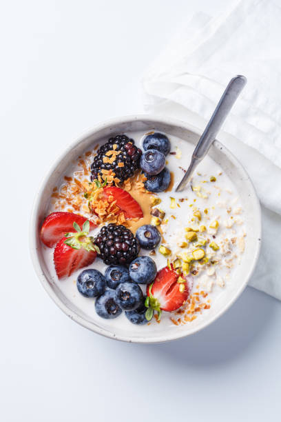 istock Oatmeal with fresh berries and nuts, white background. Healthy breakfast concept. 2154956313