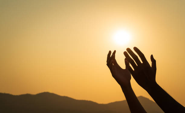 istock Closeup hands praying for blessing from god during sunset background. Hope and freedom concept. 2154957501