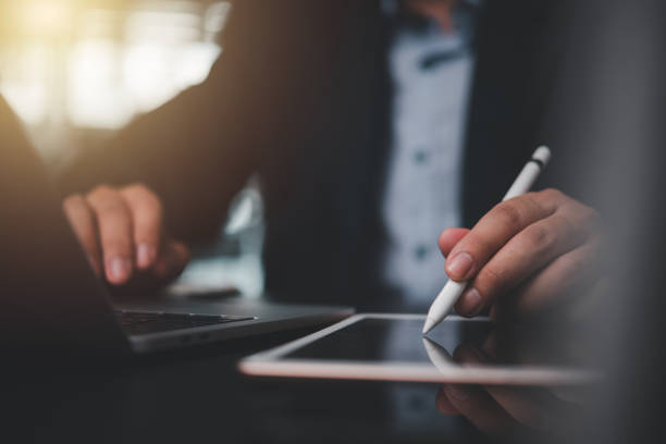 istock businessman using stylus pen working on a digital tablet 2154958758