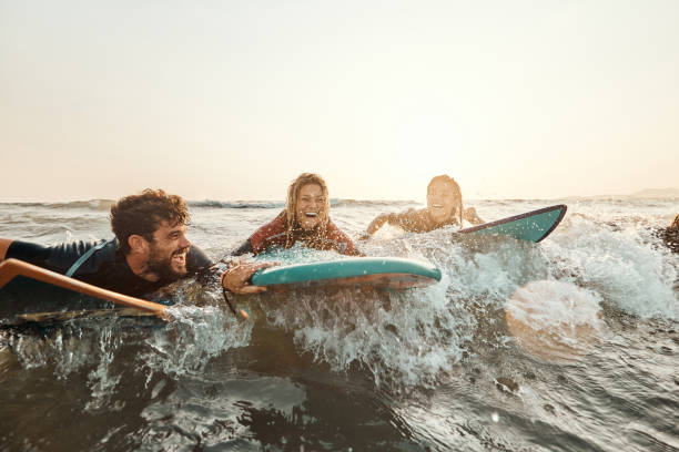 istock Cheerful surfers having fun in summer day at sea. 2154960132
