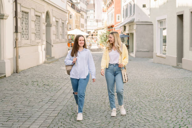 istock Female Friends walking along a street visiting downtown 2154960507