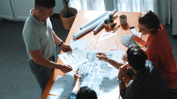 istock Top view of designer planning building while manager hold coffee. Symposium. 2154961157
