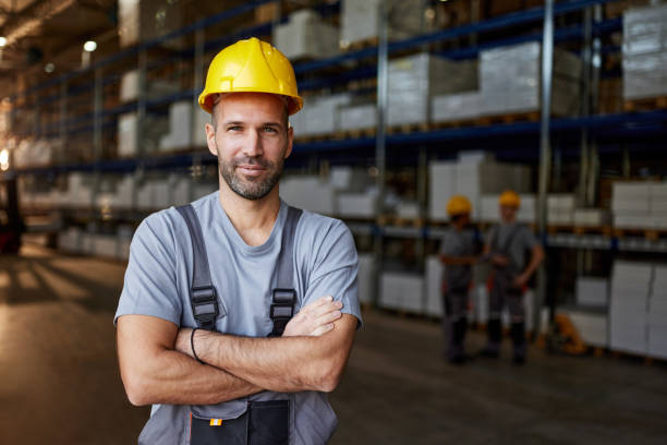 istock Smiling male worker with crossed arms in storage room. 2154961253