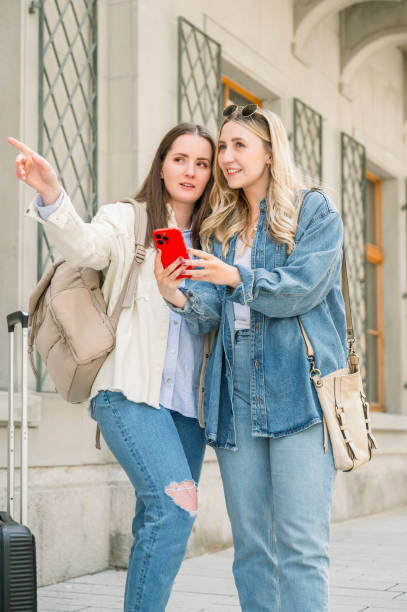 istock Tourists using mobile to get directions in the city 2154963866