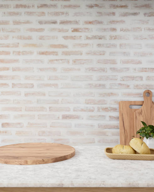 istock A showcasing space on a round wooden board on a marble table against the brick wall in a kitchen. 2154966780