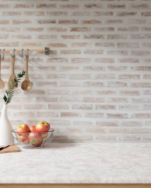 A showcasing space on a white marble tabletop against the brick wall in a Scandinavian kitchen.
