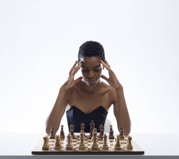 istock Focused woman playing chess and thinking 2154966953