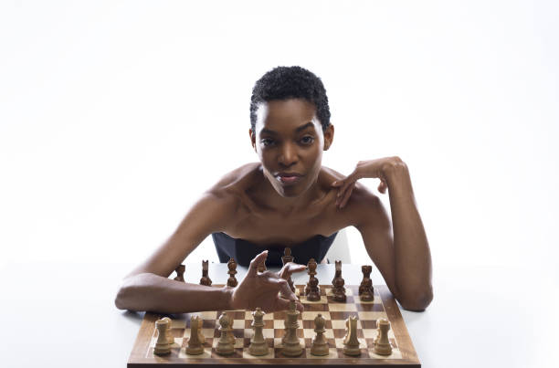 istock Sensual woman playing chess and touching the king 2154966975