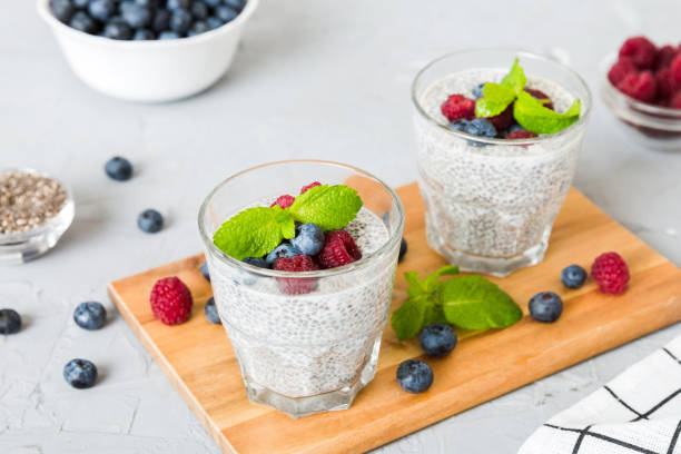 istock Healthy breakfast or morning with chia seeds vanilla pudding raspberry and blueberry berries on table background, vegetarian food, diet and health concept. Chia pudding with raspberry and blueberry 2154967258