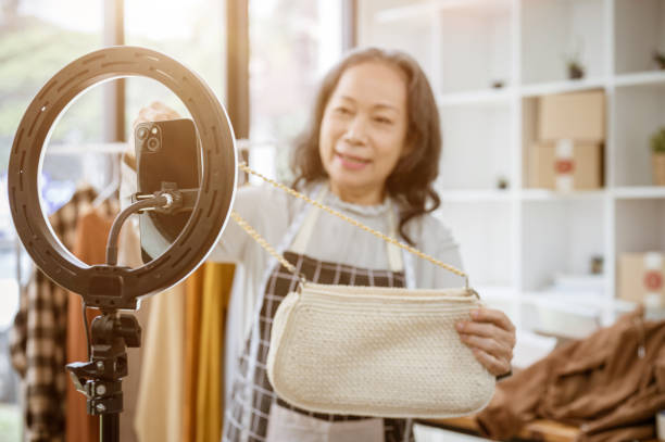 istock A selective focus image of a smartphone on an LED ring light with a seller selling her goods online. 2154968501