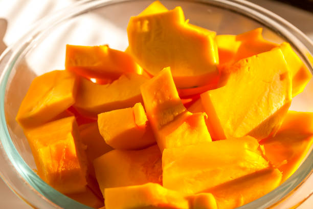Close up of mature orange Japanese heirloom winter squash pumpkin macro stock photo. Tiny pumpkin for fall decor. Edible pumpkin.