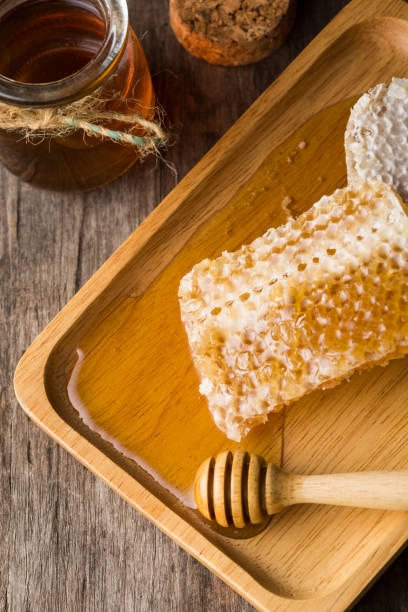 istock Honey in a glass jar with honeycomb 2154971078