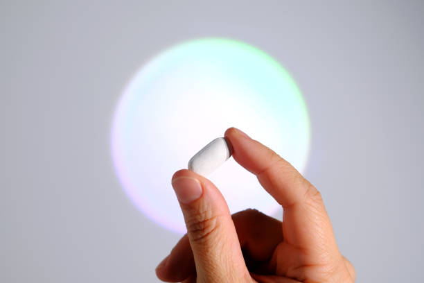 istock Tablet in hand against the background of a glowing circle. 2154971123