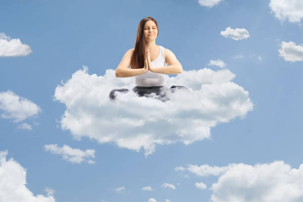 istock Young female in pajamas floating on a cloud 2154971187