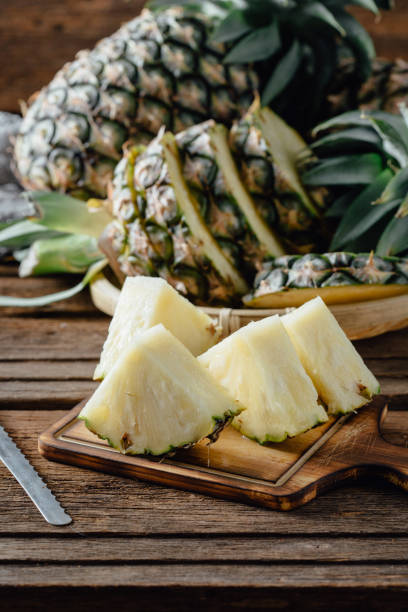 istock sliced pineapple on wooden background 2154971267