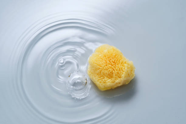 istock Natural sponge on a blue background with water. 2154971395