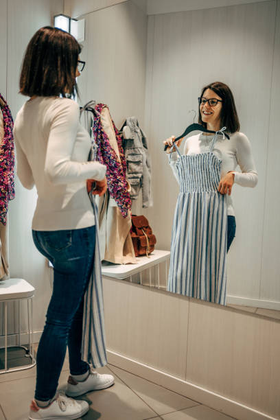 istock Woman trying clothes in a fitting room 2154971430