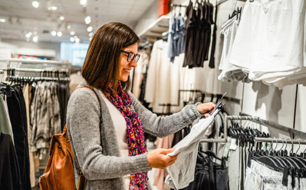 istock Woman choosing clothes at a store 2154971456